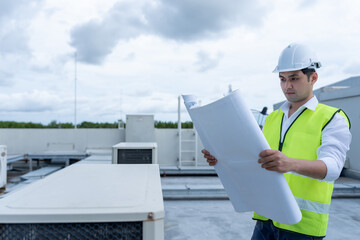 Engineers use blueprint check air condition systems on site. Contractor and inspector inspection...