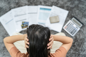 Stressed and headache woman with large bills or invoices no money to pay to expenses and credit card debt. shortage, Financial problem, bankruptcy, mortgage, loan, bankrupt, poor, empty wallet