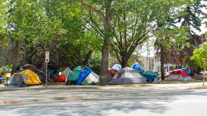 Homeless tent encampment under the trees in downtown.  Regina, Saskatchewan, Canada - July 17, 2023. 