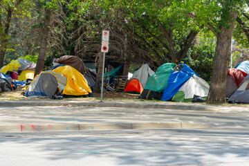 Homeless tent encampment under the trees in downtown.  Regina, Saskatchewan, Canada - July 17, 2023.  - obrazy, fototapety, plakaty