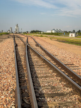 railroad tracks leading to silo and grain elevators in a rural town in Nebraska