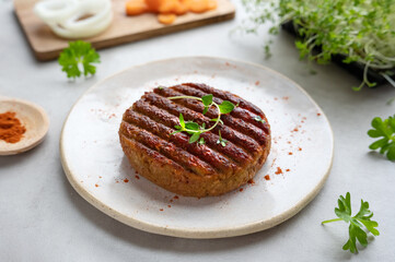 Grilled plant-based vegan soya protein burgers on the plate.