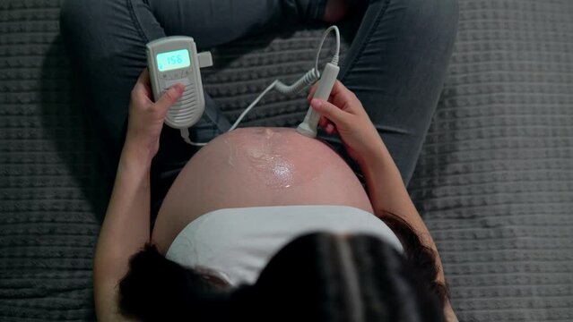 A pregnant woman as she listens to her babys hear