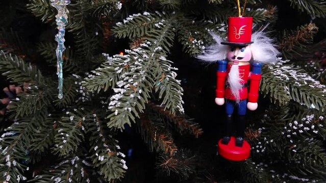 A toy red soldier and an icicle on a branch