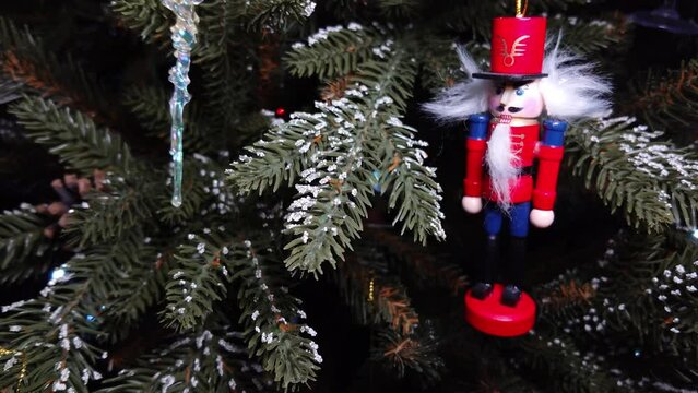 A toy red soldier hangs on the Christmas tree