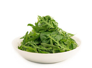 lettuce leaves in a white plate. Fresh romaine lettuce and arugula close-up in a glass bowl and on a white background