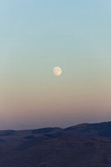 Moon above the mountains in Tajikistan