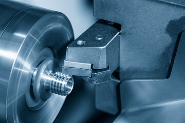 Close up scene the CNC lathe machine thread cutting at the end of metal pipe parts. - obrazy, fototapety, plakaty