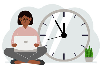 A woman sits cross-legged and holds a laptop. Next to the big clock. Time management concept, little time, much time, deadline.