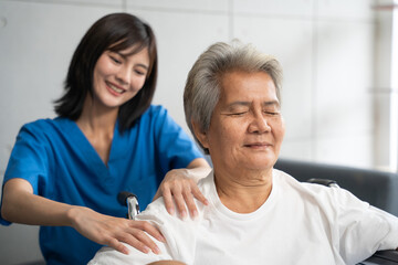 Senior woman being massage by nurse at hospital. She feeling happy and relax with massaging in clinic.