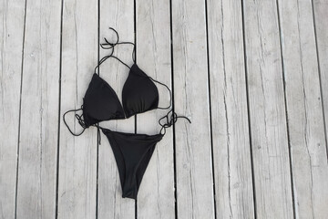 Black women's sexy swimsuit on the background of the boards