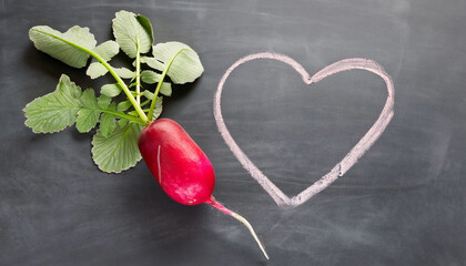 radish with leaves and a heart symbol drawn with chalk on blackboard