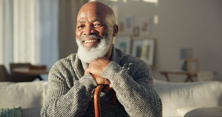 Happy, face and a black man with a cane on the sofa for support, medical help and retirement. Smile, house and portrait of a senior African person on the living room couch with a stick for walking