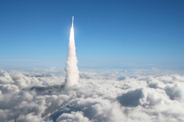 New space rocket takes off through the clouds into space. Spaceship launch above the clouds. Space...
