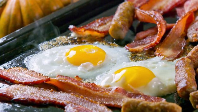 Morning Feast: 4K Video of Cooking Eggs, Sausage, and Bacon