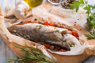 sea bass in foil with black olives tomatoes adn capers