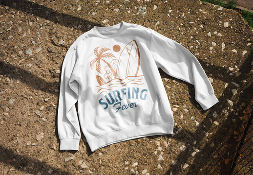 Mockup of customizable color sweatshirt lying on the ground outdoors