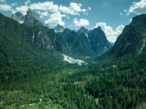 Aerial view of Tre Cime Natural Park (Drei Zinnen) seen from Dobbiaco Lake on the Dolomites mountain range, Toblach, Trentino, South Tyrol, Italy.