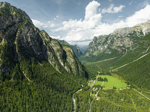 Aerial view of a road crossing the valley across Tre Cime Natural park (Drei Zinnen) on the Dolomites area, Trentino, South Tyrol, Italy.