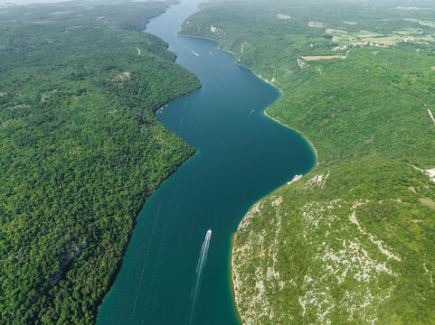 Aerial view of boats sailing along the Limski Fjord (Canal di Leme) in Sveti Lovrec, Istria, Croatia.