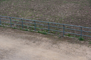 Dirt field pavement and metal railings