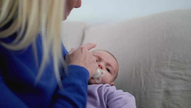 Newborn baby and latin mother hold infant son at home - Family mum and child relationship