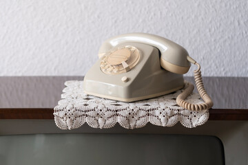 Old white Rotary Telephone with Disc Dial with finger, putting retro phone reciver down, hanging...