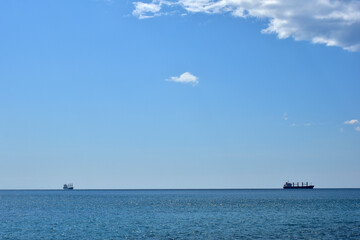 Two ships on open sea on a sunny day. Background panorama of sea, ocean nature beauty. 