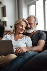 shot of a mature couple using a laptop while relaxing on the sofa at home
