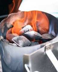 Charcoal briquettes lighting up in chimney