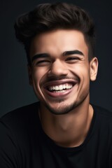 Fototapeta premium shot of a young man smiling while posing in studio