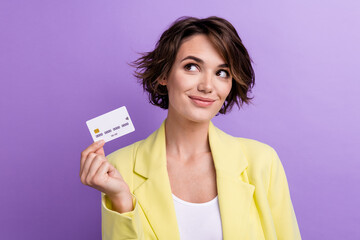 Photo of charming young woman yellow lime suit holding template debit card dreams look mockup...