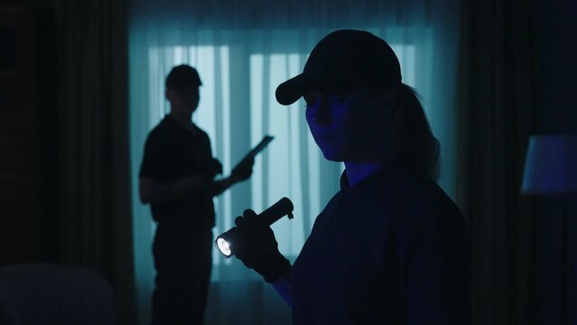 Closeup shot of police officers in uniform standing in the dark room. Crime scene creative concept.