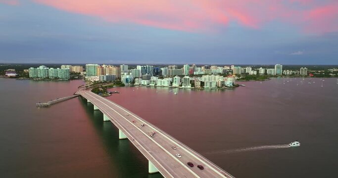 Sarasota city, Florida at sunset with waterfront office highrise buildings and John Ringling Causeway leading from downtown to St. Armands Key. Development of housing and transportation in the US