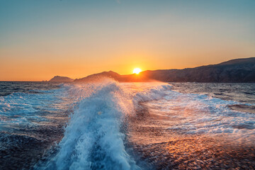 Sunset on the sea with waves and splashes between Capri and Positano, Amalfi coast, Italy