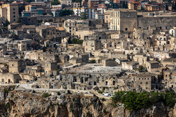 Naklejka premium Panoramic view of Sassi di Matera a historic district in the city of Matera, well-known for their ancient cave dwellings from the Belvedere di Murgia Timone, Basilicata, Italy