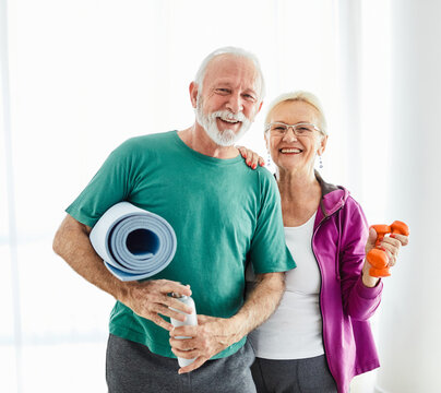 senior active exercise woman man couple training sport fitness mat gym fit pilates home love together family healthy smiling happy elderly water bottle