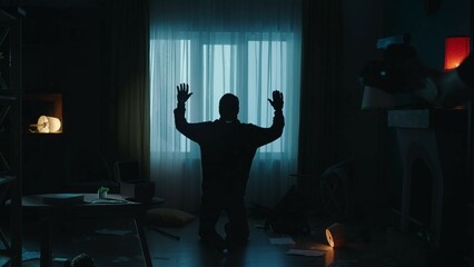 The arrest of a burglar at the crime scene, in a dark apartment . The offender is on his knees,...