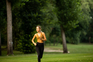 Pretty young woman running in the park