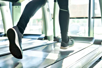Foto op Aluminium Fitness sport treadmill gym running shoe foot leg jogging closeup fitness woman athlete exercising equipment healthy training exercise motion active activity cardio run