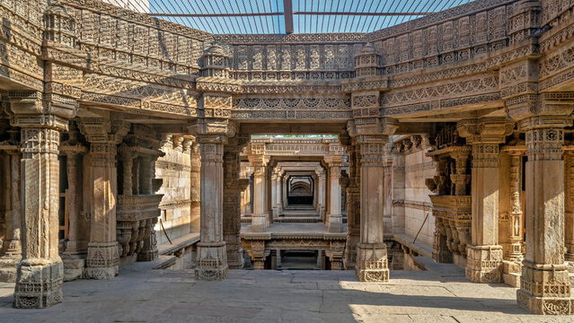 Intricate carvings and blue sky inside heritage structure of Adlaj step-well also known as Rudabai step-well and Rani ki vav .