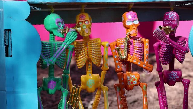 Colorful skeletons vibrantly painted, used as decorations for Dia de los Muertos. Day of the dead celebrations, a famous Hispanic holiday