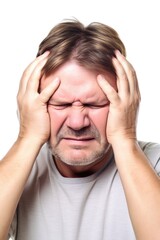 studio shot of a man holding his head in pain against a white background