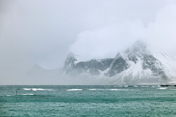 Stormy winter clouds over Sandbotnen Beach in Lofoten Archipelago, Norway, Europe