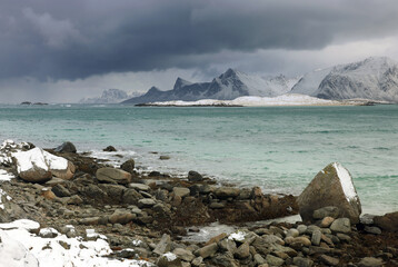 Stormy winter clouds over Sandbotnen Beach in Lofoten Archipelago, Norway, Europe