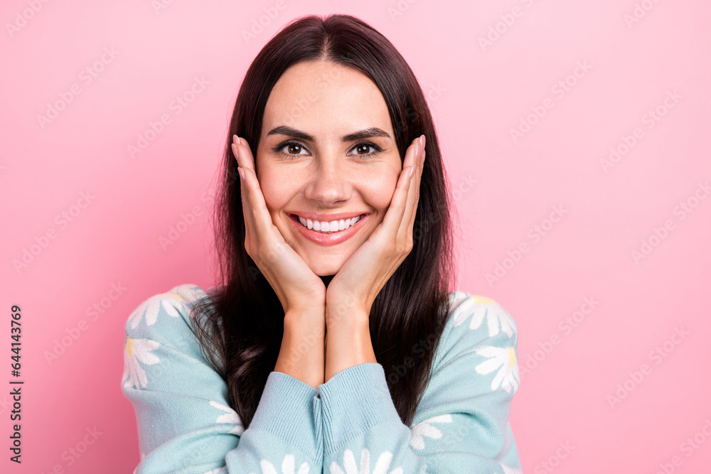 Sticker Photo of positive optimistic woman with straight hairdo dressed blue cardigan hold palms on cheekbones isolated on pink color background