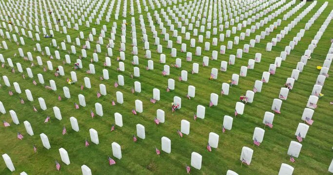 Sarasota National Cemetery with many white tombstones on green grass lawn. Memorial Day concept