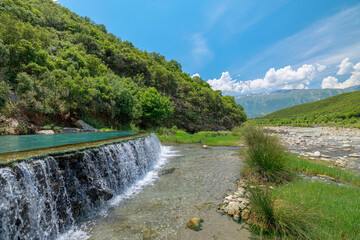Fototapeta na wymiar The Kadiut Bridge pool is nestled within lush landscapes and boasts the soothing sounds of nature. This secluded oasis provides a peaceful retreat from the fast-paced lifestyle in Albania.