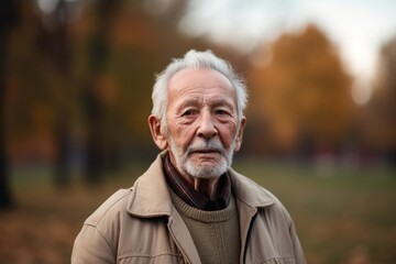 portrait of a handsome senior man strolling at the park