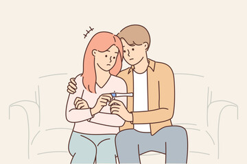 Problem of infertility in man and woman sitting on couch with negative pregnancy test in hands